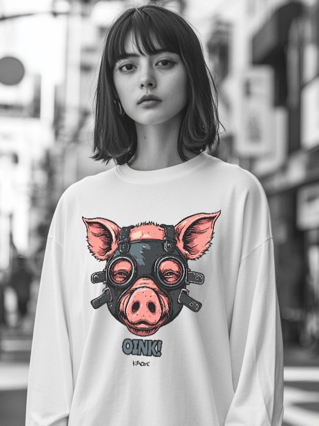 A young woman with short hair wears a white oversized sweatshirt featuring a playful pig graphic with a black mask and glasses, set against a blurred urban background.
