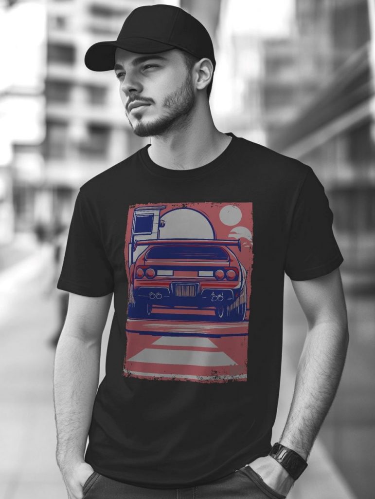 Confident young man wearing a black t-shirt with a colorful vintage car graphic and a black cap on an urban street