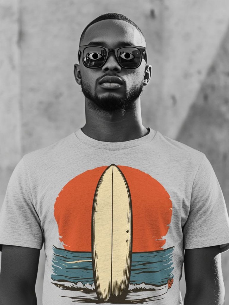 A confident young man wearing stylish sunglasses and a light gray t-shirt with a retro surfboard graphic, set against a textured black and white background. The t-shirt features a vibrant graphic of an orange sun setting over blue waves, perfect for a beach-inspired aesthetic.