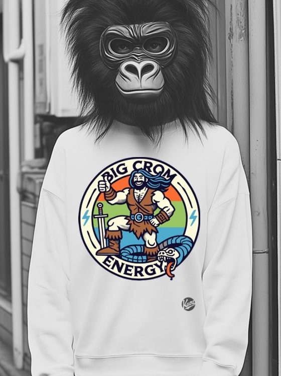 Person in white sweatshirt with vibrant t-shirt design showcasing muscular character holding sword, text BIG CROM ENERGY , and colorful rainbow background.