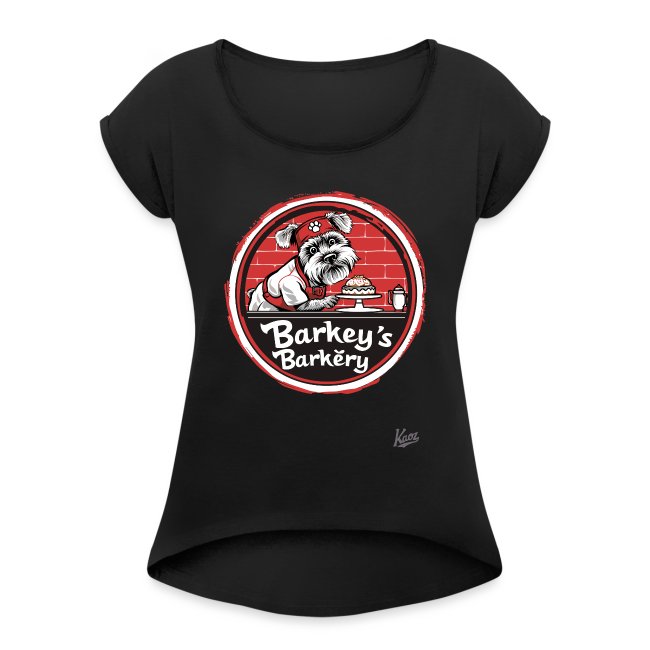 Black T-shirt featuring a cartoon dog in a chef's hat and apron presenting a cake, framed by a red border with 'Barkey's Barkery' text, against a red brick pattern.